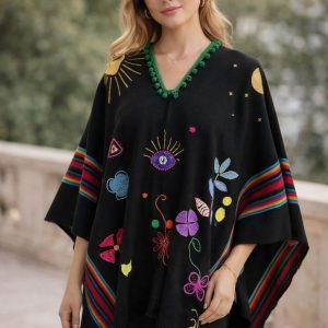 One of a kind black hand embroidered Ecuadorian poncho with artisan patchwork and ancestral symbols on a mannequin, ethical slow fashion for USA & Canada